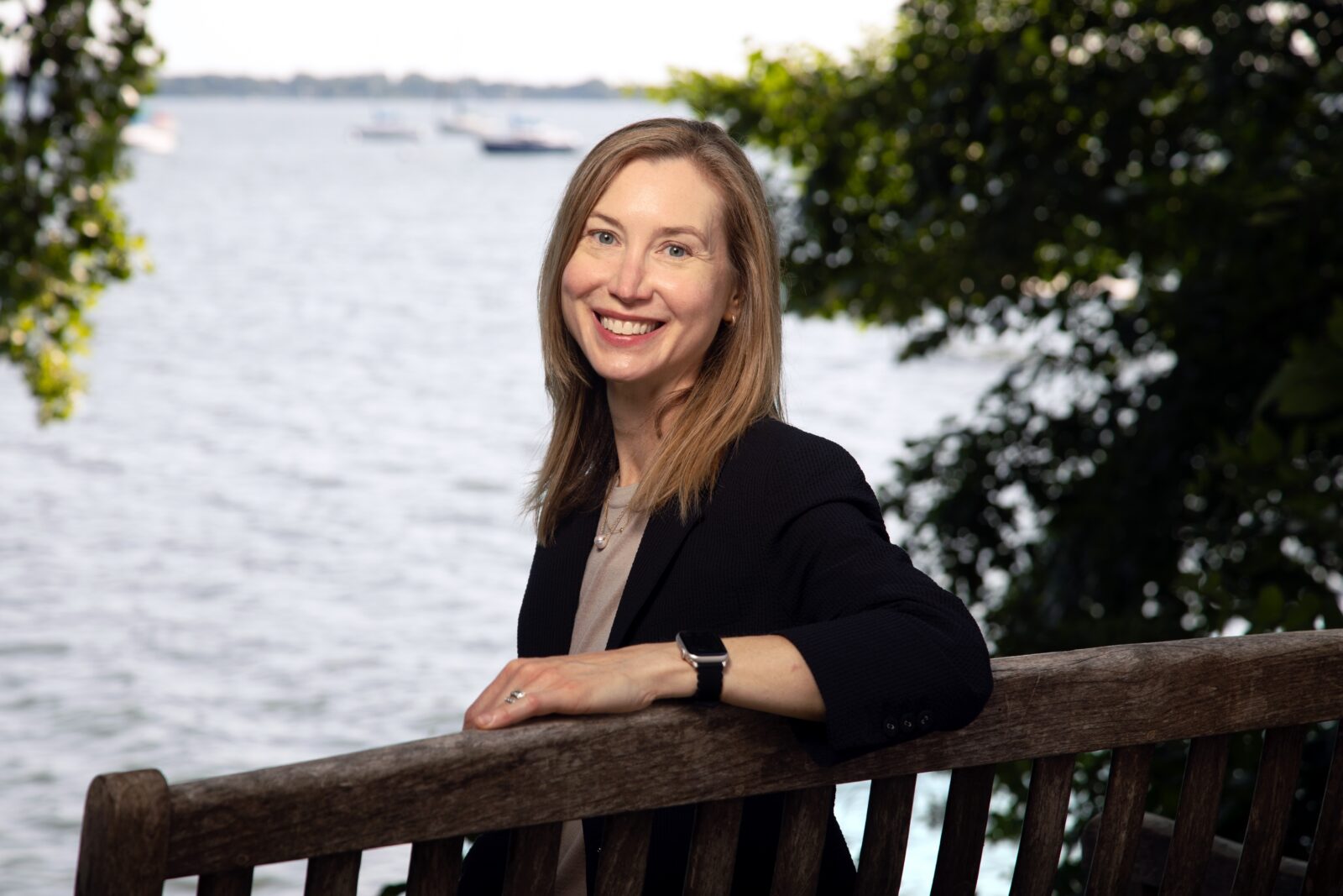 Sarah Ashworth sitting on a bench infront of a lake in Madison, Wisconsin.